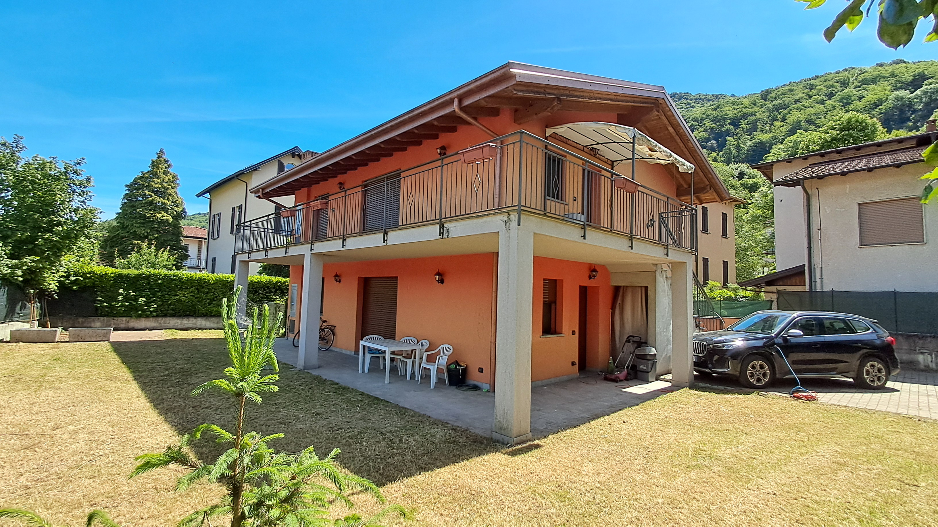 Vista della casa dal giardino con terrazzo e portico